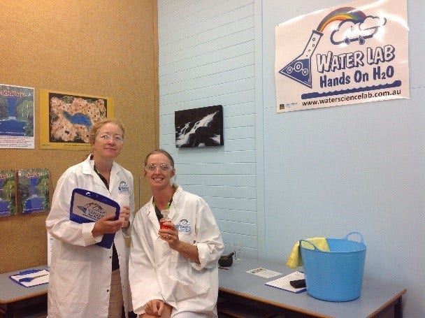2 educators in labcoats in waterlab